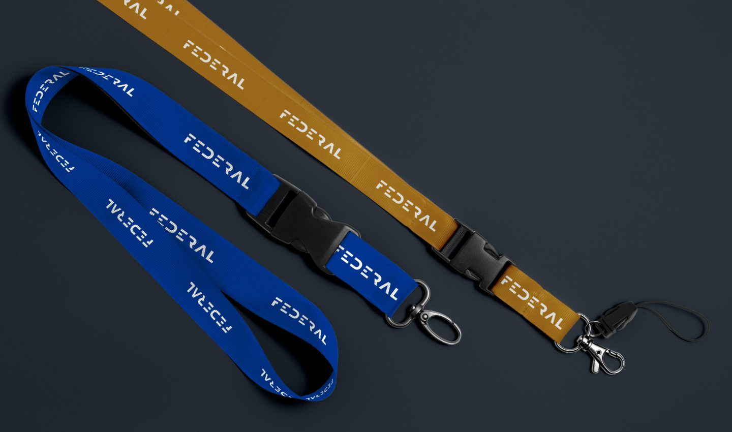 Federal branded lanyards in blue and golden yellow with badge clips